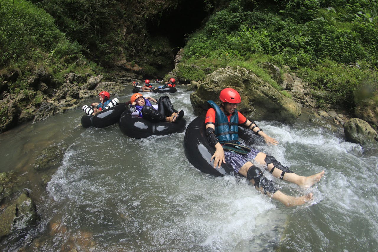 Thrill-seekers enjoy a tubing adventure through a scenic river in Semanu, Indonesia.